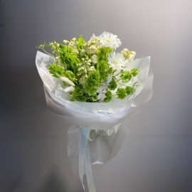 Bouquet made of moluccella, delphinium, and scabiosa